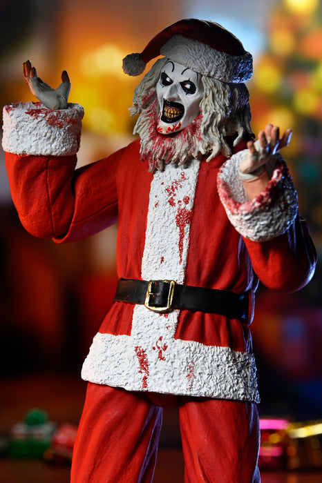 NECA Figura de Accion Ultimate: Terrifier 3 - Santa Suit Art the Clown Bloody Version 7 Pulgadas