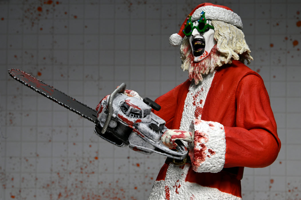 NECA Figura de Accion Ultimate: Terrifier 3 - Santa Suit Art the Clown Bloody Version 7 Pulgadas