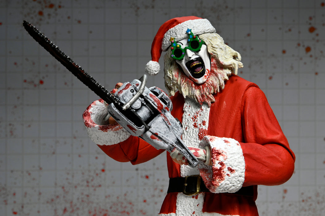 NECA Figura de Accion Ultimate: Terrifier 3 - Santa Suit Art the Clown Bloody Version 7 Pulgadas