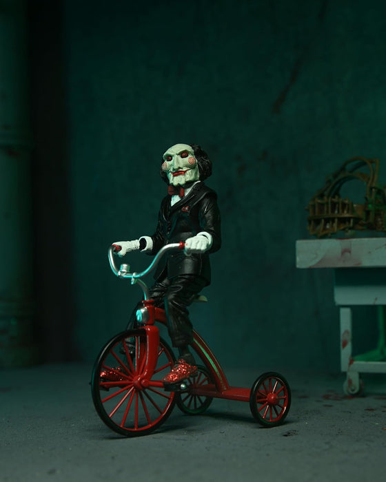 NECA Figura de Accion Ultimate: Saw - Asesino Jigsaw Con Tunica Negra 7 Pulgadas